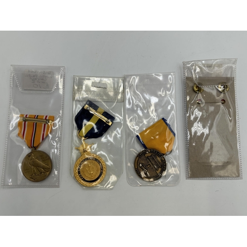 2353 - Four United States of America military medals to include Navy Service, National Defence etc.