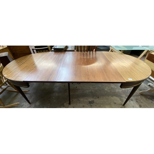 102 - A Regency style mahogany D end extending dining table on reeded supports - approx. 75cm high x 110cm... 