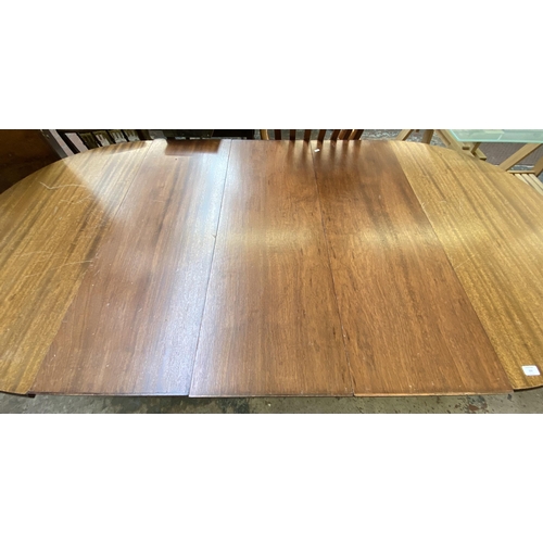 102 - A Regency style mahogany D end extending dining table on reeded supports - approx. 75cm high x 110cm... 