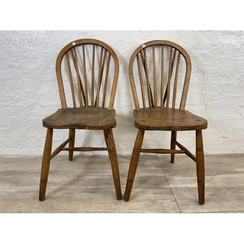 103 - A pair of early 20th century elm and beech Windsor dining chairs