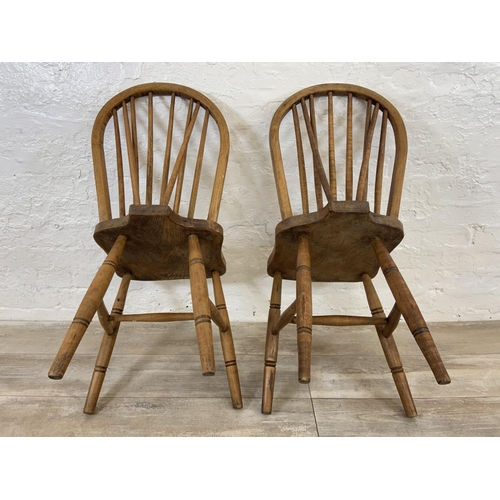 103 - A pair of early 20th century elm and beech Windsor dining chairs