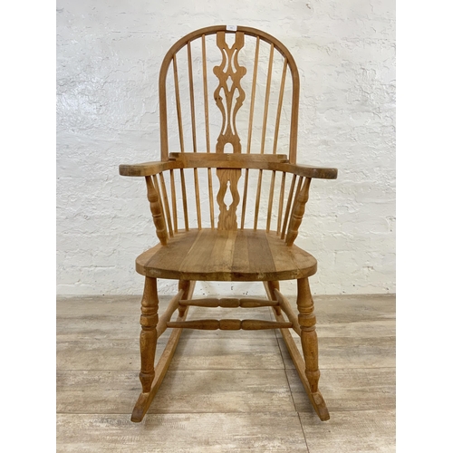 105 - A 19th century style oak Windsor rocking chair