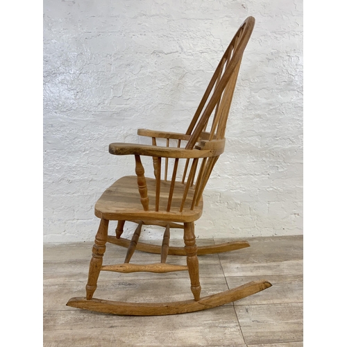 105 - A 19th century style oak Windsor rocking chair