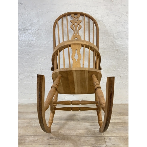 105 - A 19th century style oak Windsor rocking chair