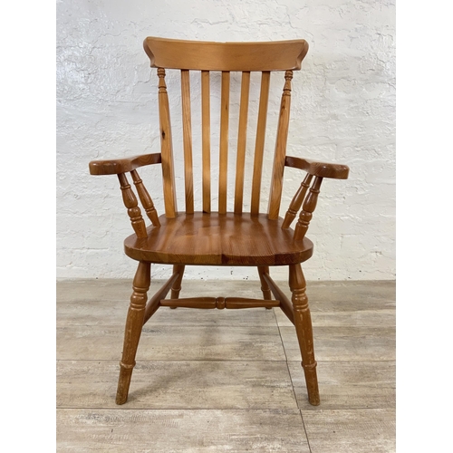 107 - A Victorian style pine spindle back farmhouse armchair