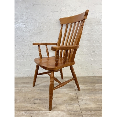 107 - A Victorian style pine spindle back farmhouse armchair