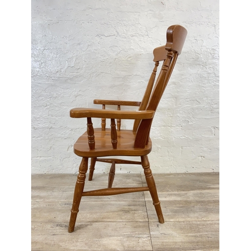 107 - A Victorian style pine spindle back farmhouse armchair