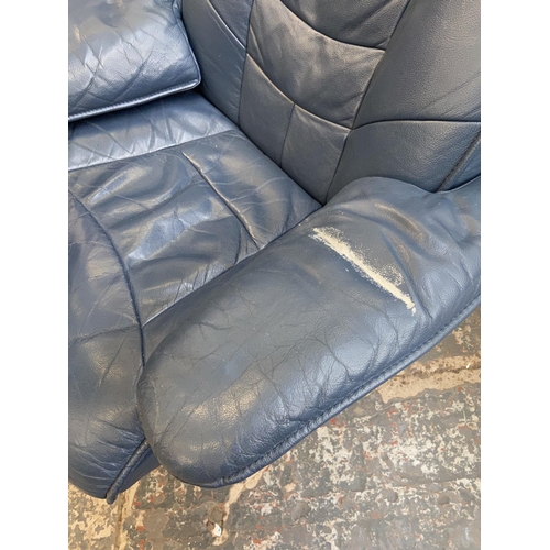 109 - A Stressless style blue leather swivel reclining armchair