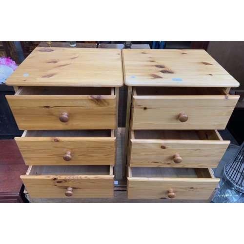 112 - A pair of pine bedside chests of drawers - approx. 61cm high x 44cm wide x 38cm deep