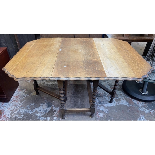 113 - An early 20th century oak pie crust edge drop leaf gate leg barley twist dining table - approx. 72cm... 