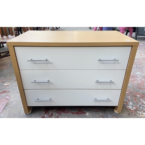 119 - Two pieces of modern white laminate and beech effect bedroom furniture, one chest of drawers and one... 