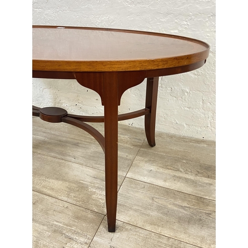 121 - A Regency style inlaid yew wood and mahogany oval coffee table - approx. 52cm high x 64cm wide x 112... 