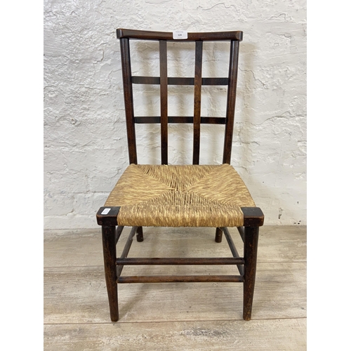 124 - An Arts & Crafts Liberty & Co style beech lattice back and rush seated child's chair - approx. 65cm ... 