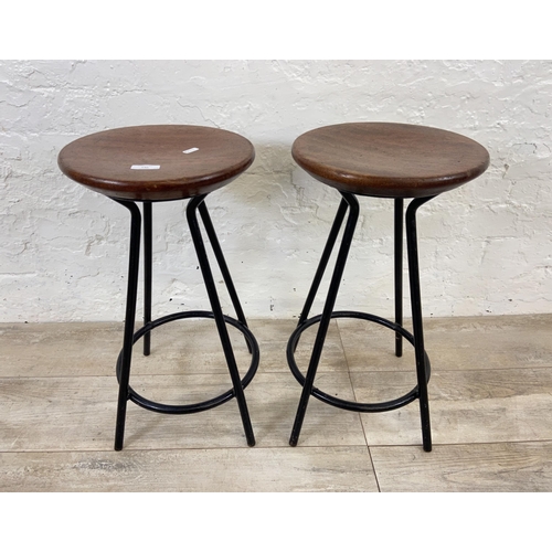 130 - A pair of mid 20th century mahogany and black tubular metal industrial type stools - approx. 56cm hi... 