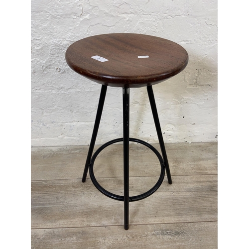 130 - A pair of mid 20th century mahogany and black tubular metal industrial type stools - approx. 56cm hi... 