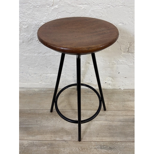 130 - A pair of mid 20th century mahogany and black tubular metal industrial type stools - approx. 56cm hi... 