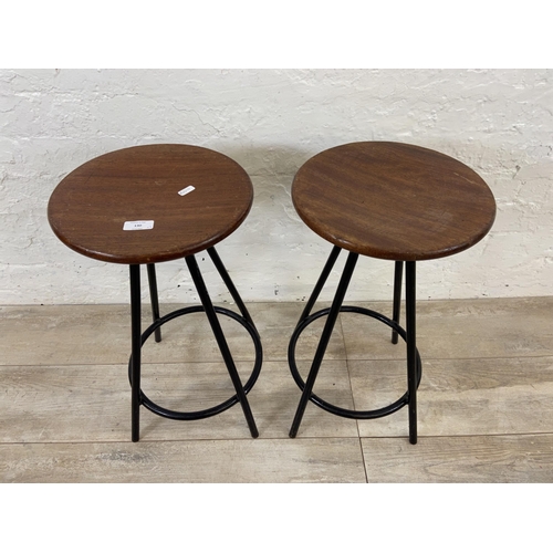 130 - A pair of mid 20th century mahogany and black tubular metal industrial type stools - approx. 56cm hi... 