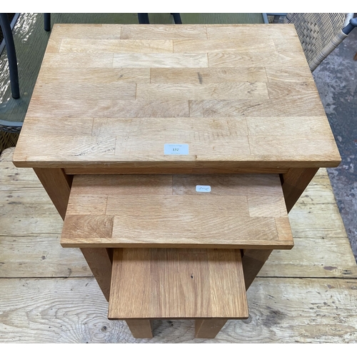 132 - A Julian Bowen solid oak nest of three tables - approx. 49cm high x 50cm wide x 35cm deep