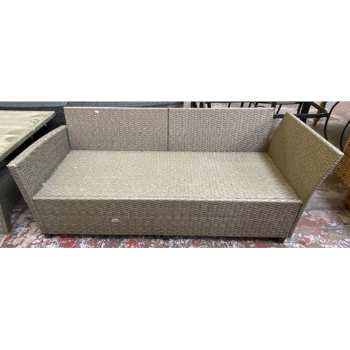 135 - A Casaria plastic rattan effect three piece patio set comprising rectangular table and two sofas