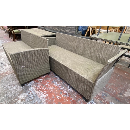 135 - A Casaria plastic rattan effect three piece patio set comprising rectangular table and two sofas