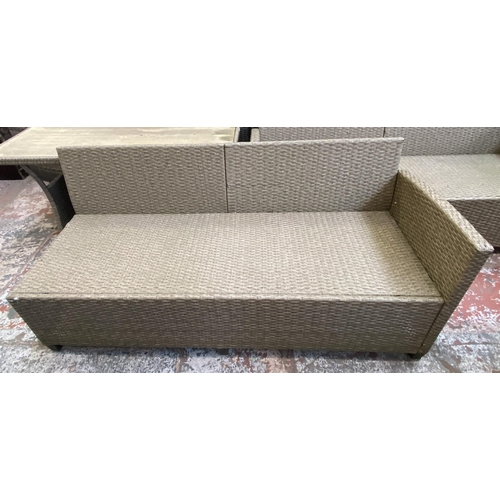 135 - A Casaria plastic rattan effect three piece patio set comprising rectangular table and two sofas