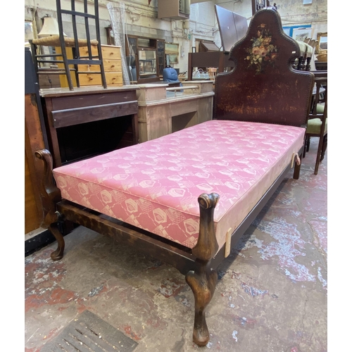 138 - An early 20th century beech single bed frame with hand painted floral design brown leather metal stu... 