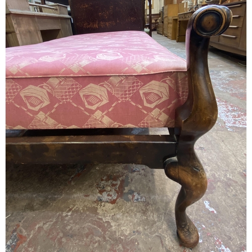 138 - An early 20th century beech single bed frame with hand painted floral design brown leather metal stu... 