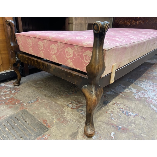 138 - An early 20th century beech single bed frame with hand painted floral design brown leather metal stu... 