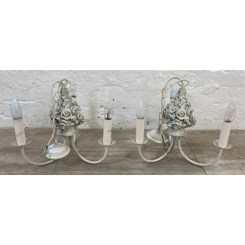 139 - A pair of French style white painted floral three branch chandeliers - approx. 60cm drop