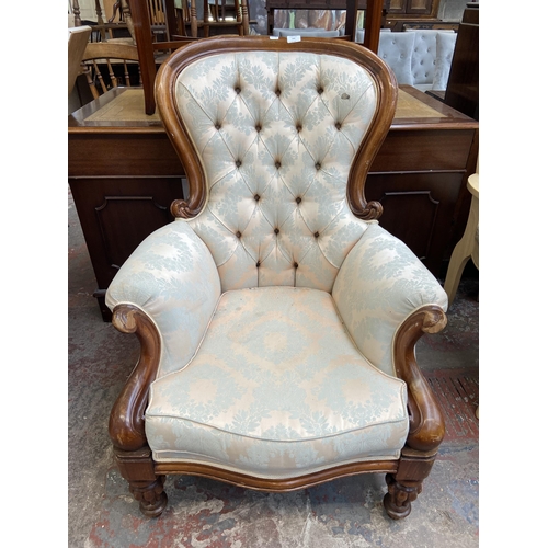 141 - A Victorian style mahogany and fabric button back upholstered armchair