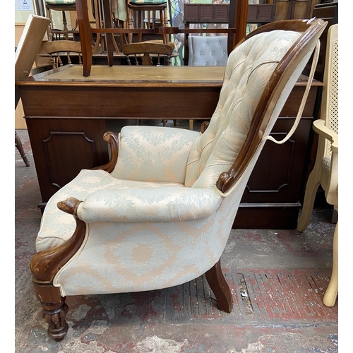 141 - A Victorian style mahogany and fabric button back upholstered armchair