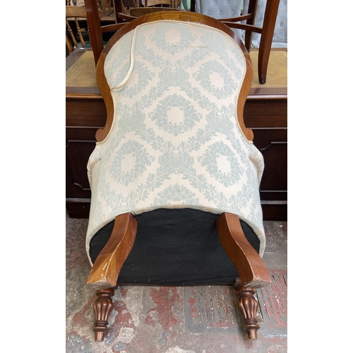 141 - A Victorian style mahogany and fabric button back upholstered armchair