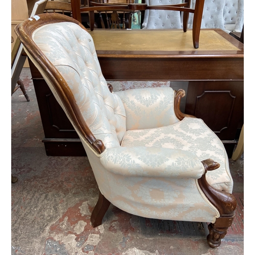 141 - A Victorian style mahogany and fabric button back upholstered armchair