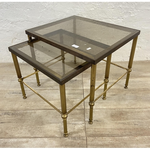 145 - Two items, one Hollywood Regency brass and smoked glass nest of two tables - approx. 46cm high x 56c... 