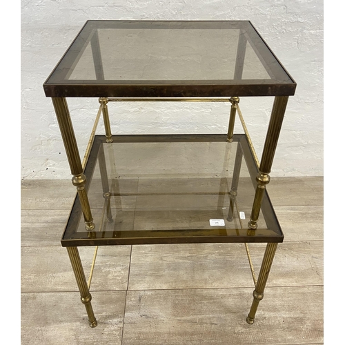 145 - Two items, one Hollywood Regency brass and smoked glass nest of two tables - approx. 46cm high x 56c... 