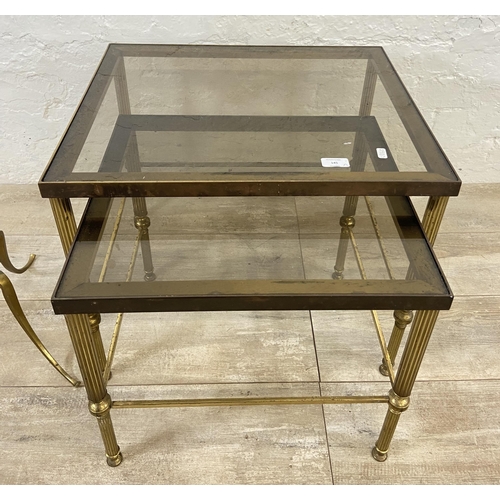 145 - Two items, one Hollywood Regency brass and smoked glass nest of two tables - approx. 46cm high x 56c... 