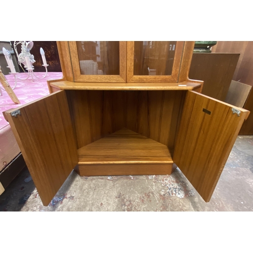 147 - A mid 20th century Turnidge of London teak free standing corner display cabinet - approx. 170cm high... 