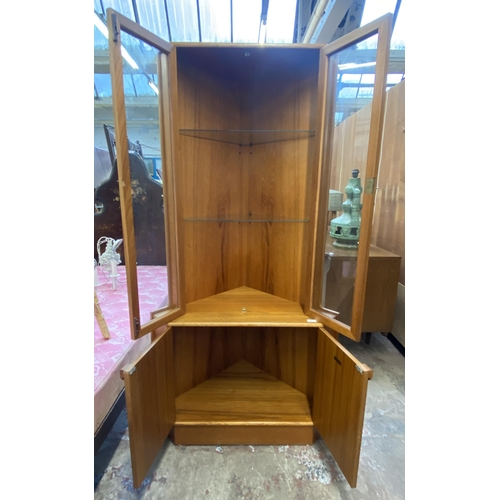 147 - A mid 20th century Turnidge of London teak free standing corner display cabinet - approx. 170cm high... 