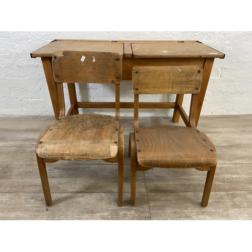 15 - A mid 20th century beech twin child's school desk and two bentwood child's chairs - approx. 62cm hig... 