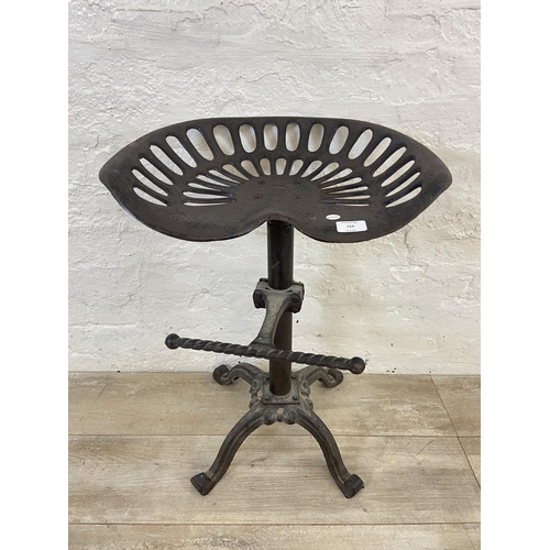 153 - A cast iron adjustable tractor seat stool - approx. 66cm high