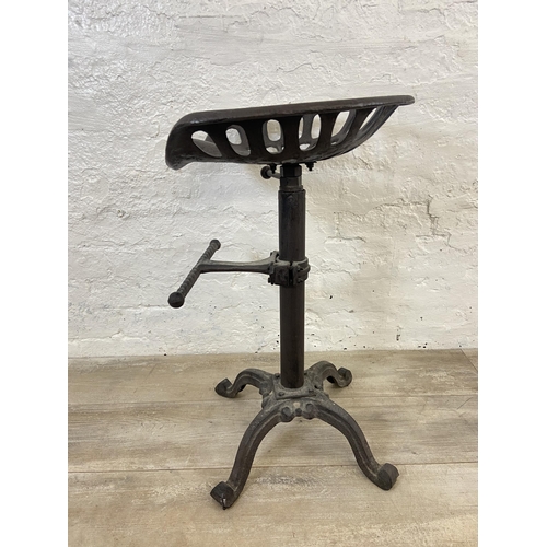 153 - A cast iron adjustable tractor seat stool - approx. 66cm high