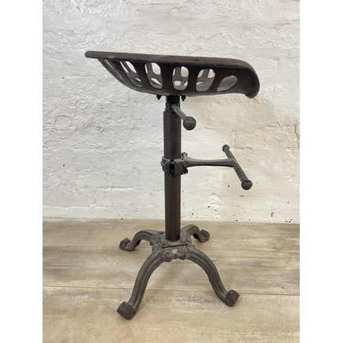 153 - A cast iron adjustable tractor seat stool - approx. 66cm high