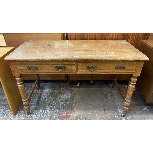 154 - A Victorian Aesthetic Movement satinwood two drawer writing table - approx. 74cm high x 122cm wide x... 