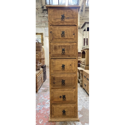 155 - A pine chest of drawers - approx. 137cm high x 39cm wide x 34cm deep