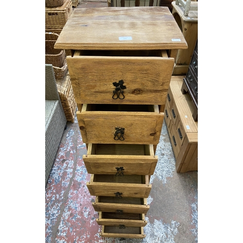 155 - A pine chest of drawers - approx. 137cm high x 39cm wide x 34cm deep