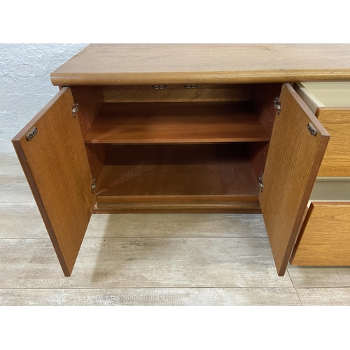 16 - A mid 20th century Meredew teak low sideboard - approx. 56cm high x 135cm wide x 45cm deep