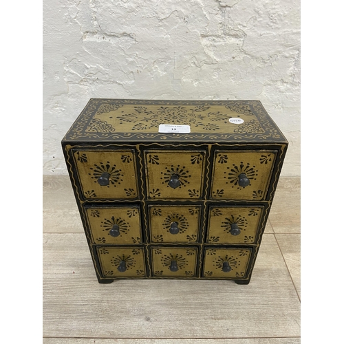 19 - An Indian hand painted nine drawer spice cabinet/miniature chest of drawers - approx. 28cm high x 25... 