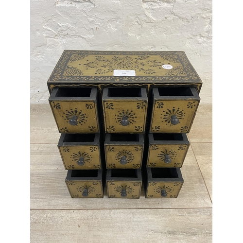 19 - An Indian hand painted nine drawer spice cabinet/miniature chest of drawers - approx. 28cm high x 25... 