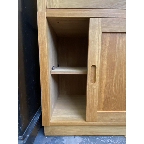 27 - A Laura Ashley Milton oak compartmental storage system - approx. 129cm high x 221cm wide x 40cm deep