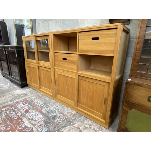 27 - A Laura Ashley Milton oak compartmental storage system - approx. 129cm high x 221cm wide x 40cm deep